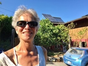 Joanna Zilsel has solar panels on her roof and an electric car in her driveway.