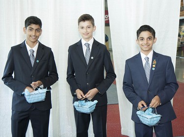 Three young volunteers welcome the crowds at BC Place with commemorative Diamond Jubilee pins and smiles.