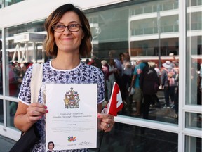 Byrdie Funk shows off her Certificate of Canadian Citizenship outside of a citizenship ceremony at Canada Place in Vancouver B.C. on Saturday, July 1, 2017.