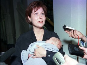 2001: Christy Clark, then deputy premier and minister of education, handles reporters’ questions while holding her one-month-old son Hamish at the B.C. legislature.