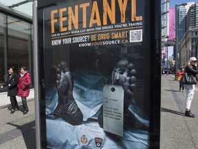 An anti-fentanyl ad is seen on a sidewalk in downtown Vancouver on April 11. A tag hanging from a dead man's left toe says the cause of death was an overdose of fentanyl, 'unknowingly taken with other drugs.'