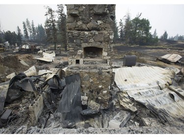 Remains of a private residence on Highway 20 Thursday, July 13, 2017 that burned down due to a wildfire raging through the Chilcotin.