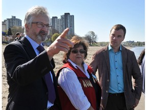 Geoff Meggs, left, Carleen Thomas and MLA Spencer Chandra Herbert check out the water at English Bay after an oil spill in Vancouver on April 8, 2015.