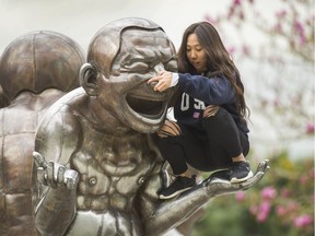 Kate Dobashi climbs up onto the A-maze-ing Laughter sculpture in Vancouver, B.C., April 17, 2017.