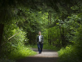 Steven Pettigrew walks through Hawthorne Park near his home in Surrey. Pettigrew is concerned about city plans to build a road through the park.