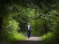 Steven Pettigrew walks through Hawthorne Park near his home in Surrey. Pettigrew is concerned about city plans to build a road through the park.