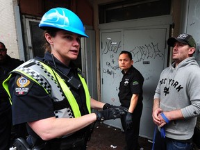 FILE PHOTO Vancouver police and city officials outside the Balmoral Hotel as resident Michael Hurlburt prepares to leave the hotel for the last time pending renovations, in Vancouver, BC., June 12, 2017.