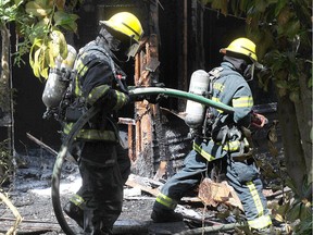 Maple Ridge fire fighters finish fighting a blaze at 207th Street and Lorne Avenue in Maple Ridge, BC., July 2, 2017. The cause of the fire in under investigation and no one was believed to  in the house at the time.