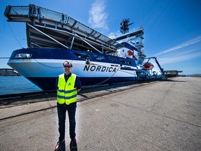 Capitan Matti Westerlund in front of multipurpose icebreaker Nordica. The ship, docked in North Vancouver will transit the Northwest Passage this July.