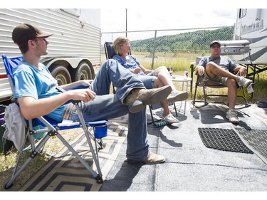 Chad Braaten (left) sits with the parents Kelly and Darrel at the Prince George Exhibition Grounds in Prince George, BC, after they had to leave their home in 150 Mile House as the wildfires were burning out of control, July, 10, 2017.