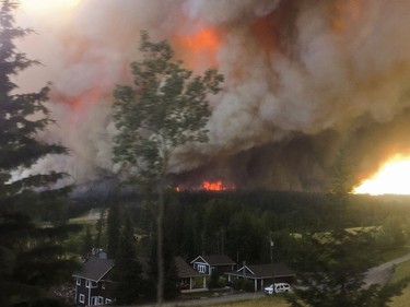Canada's big banks and other companies are donating sizeable sums to the Canadian Red Cross to help the victims of the wildfires in British Columbia. A large wildfire burns on the ridge behind the Braaten Home in 153 Mile House, BC, July, 7, 2017 forcing the family to flee to Prince George.