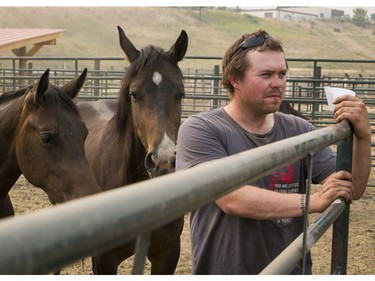 Logan Piesse of Rocky Mountain House Alberta watches a horses get loaded into his trailer at the Williams Lake Stampede Grounds before transporting it and 6 others to Prince George from Williams Lake, BC, July, 11, 2017.