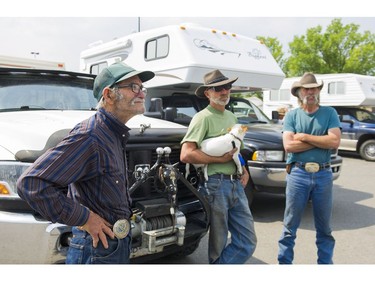 Curtis Randall (left) along with his two sons Sandy (centre) and Stewart take a break in Quesnel, BC, while on their way to Prince George after being evacuated from the area northeast of Williams Lake, July, 16, 2017.