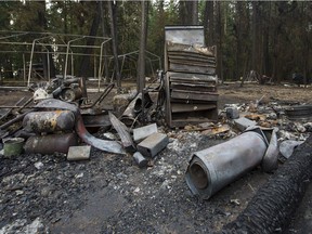 The remains of a tool chest and machinery that were burnt along with the out building on a property is seen after the Soda Creek Fire jumped across the Fraser River near Alexandria in the Interior on July 16.