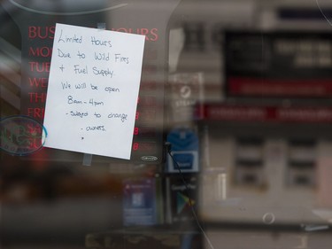 A sign indicating limited hours is posted on a window at the gas station in Horsefly.