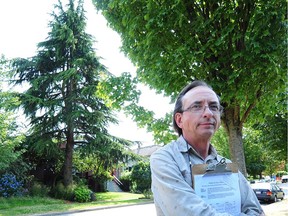 Tony Dean, who is rallying to spare from the axe a pair of decades old trees as his neighbour prepares to knock down his empty home and rebuild in Vancouver, BC., July 17, 2017.