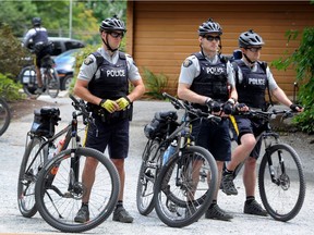 RCMP bike patrol in action as Supt Chuck McDonald of the Burnaby RCMP speaks to media at Central Park in Burnaby, BC., July 26, 2017.