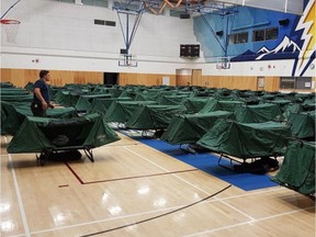 Cots are set up at a reception centre at Chilliwack Secondary School. Close to 70 evacuees fleeing wildfires in the B.C. Interior had arrived by noon Sunday.