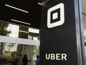 People make their way into the building that houses the headquarters of Uber, Wednesday, June 21, 2017, in San Francisco.