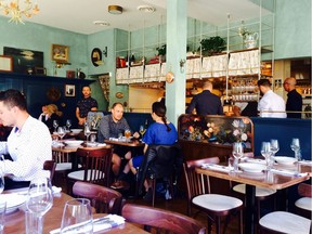 The dining room at St. Lawrence Restaurant with photos from chef/owner J.C. Poirier's childhood.