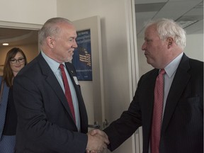 B.C. Premier John Horgan (left) shakes hands with the National Association of Home Builders CEO Gerald Howard in Washington, Thursday, July 27, 2017.
