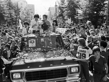 The city celebrates with a victory parade down Granville Street for the NASL champion Vancouver Whitecaps, with goalie Phil Parkes (left) and captain John Craven (right) with the trophy. September 9, 1979.