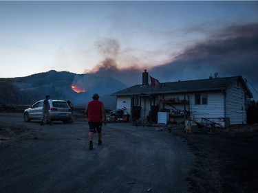Darin Minnabarriet

Darin Minnabarriet walks to his house that survived a wildfire to empty his freezer on the Ashcroft First Nation, as a fire burns on a mountain in the distance near Ashcroft, B.C., late Sunday July 9, 2017. THE CANADIAN PRESS/Darryl Dyck ORG XMIT: VCRD227
DARRYL DYCK,