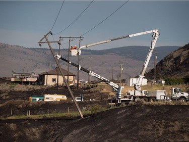 Workers

B.C. Hydro workers repair power lines above the remains of mobile homes destroyed by wildfire in Boston Flats near Ashcroft, B.C., on Sunday July 9, 2017. B.C. government officials now estimate that 7,000 people have been evacuated from their homes due to wildfires burning in the province. THE CANADIAN PRESS/Darryl Dyck ORG XMIT: VCRD240
DARRYL DYCK,