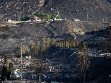 Workers

B.C. Hydro workers repair power lines above the remains of mobile homes destroyed by wildfire in Boston Flats near Ashcroft, B.C., on Sunday July 9, 2017. B.C. government officials now estimate that 7,000 people have been evacuated from their homes due to wildfires burning in the province. THE CANADIAN PRESS/Darryl Dyck ORG XMIT: VCRD236
DARRYL DYCK,
