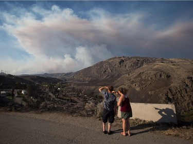 People

Ashcroft residents stop to view the remains of mobile homes destroyed by wildfire in Boston Flats, B.C., as a fire burns in the distance east of Cache Creek, on Sunday July 9, 2017. B.C. government officials now estimate that 7,000 people have been evacuated from their homes due to wildfires burning in the province. THE CANADIAN PRESS/Darryl Dyck ORG XMIT: VCRD230
DARRYL DYCK,