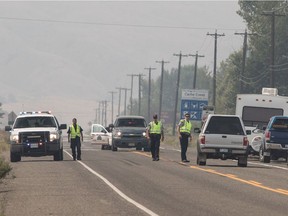 RCMP talk with travellers along the highway road block just outside of Cache Creek last week as residents were allowed back home. About 20,000 B.C. residents remain out of their homes.