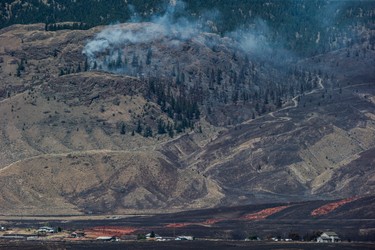 A wildfire burns on a mountain above the Ashcroft First Nation in Ashcroft, B.C., on Sunday, July 9, 2017.