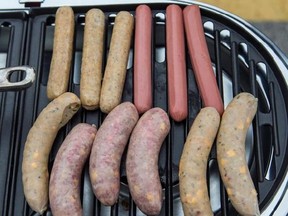 Sausages are shown on a grill at Miller Park before opening day featuring the Milwaukee Brewers and the San Francisco Giants Monday, April 4, 2016, in Milwaukee. A federally funded study has found that 20 per cent of sausages sampled from grocery stores across Canada contained meats that weren&#039;t on the label. THE CANADIAN PRESS/AP Photo/Tom Lynn