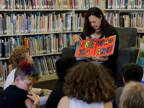 In this Wednesday, July 12, 2017 photo, Sandra Collins, executive director and founder of enGender, reads a book to campers at the Bay Area Rainbow Day Camp in El Cerrito, Calif. Collins says, ‚ÄúA lot of these kids have been bullied and had trauma at school. This is a world where none of that exists, and they&#039;re in the majority. That‚Äôs a new experience for kids who are used to hiding and feeling small.‚Äù (AP Photo/Jeff Chiu)