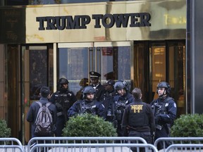 FILE - In this Nov. 17, 2016 file photo, security personnel stand at the front entrance of Trump Tower in New York. As President Donald Trump spends much of August at his New Jersey golf club, Democratic lawmakers are making a new push for information about how much money the federal government is spending at his for-profit properties. Democrats on the House Oversight Committee are asking that departments hand over information about their Trump-related spending by Aug. 25.  (AP Photo/Seth Wenig, File)