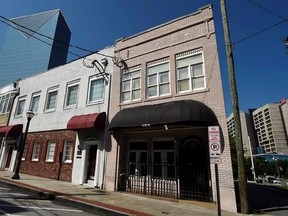 This Wednesday, July 19, 2017, photo shows a two-story brick building, right, at the northwest edge of Atlanta&#039;s old downtown. The old building is where the first country music hit was recorded in 1923 by Fiddlin&#039; John Carson. It faces the threat of demolition to make way for a Jimmy Buffett&#039;s Margaritaville restaurant. (AP Photo/Mike Stewart)