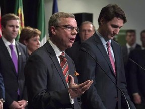 Prime Minister Justin Trudeau listens as Saskatchewan Premier Brad Wall responds to a question during a First Ministers meeting at the Canadian Museum of Nature in Ottawa on Monday, Nov. 23, 2015. With Wall&#039;s retirement as Saskatchewan&#039;s premier, Prime Minister Justin Trudeau will no longer have to contend with the harshest critic of his plan to impose a carbon tax. THE CANADIAN PRESS/Adrian Wyld