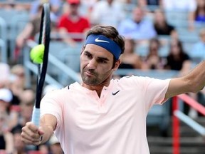Roger Federer, of Switzerland, returns the ball to Robin Haase, of the Netherlands, during Rogers Cup tennis action, in Montreal on Saturday, August 12, 2017. THE CANADIAN PRESS/Paul Chiasson