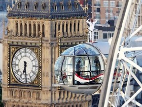 British athlete Mo Farah stands atop of a pod on the London Eye, with Big Ben&#039;s clock tower in background, as he bids a final farewell to British track competitive athletics after winning gold in the 10,000m and silver in the 5,000m at the IAAF World Championships in London, Sunday Aug. 13, 2017. Farah is due to retire from the track at the end of the month, after the Diamond League in Zurich, and hopes to focus on the marathon distance. (Jonathan Brady/PA via AP)