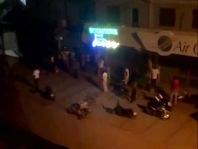 This image taken from video, early Monday, Aug. 14, 2017, shows a top shot of a street near a Turkish restaurant that came under an attack in Ouagadougou. Suspected Islamic extremists opened fire at a Turkish restaurant in the capital of Burkina Faso late Sunday, killing at least 18 people in the second such attack on a restaurant popular with foreigners in the last two years. (El Hadji Macky Diouf via AP)