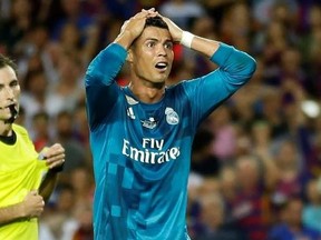 Real Madrid&#039;s Cristiano Ronaldo, right, reacts after Referee Ricardo de Burgos shows a second yellow card during the Spanish Supercup, first leg, soccer match between FC Barcelona and Real Madrid at the Camp Nou stadium in Barcelona, Spain, Sunday, Aug. 13, 2017. Cristiano Ronaldo was banned for five games on Monday after shoving a referee following his red card for diving in Real Madrid&#039;s 3-1 win over Barcelona in the season-opening Spanish Super Cup. (AP Photo/Manu Fernandez)