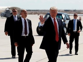FILE - In this Tuesday, Aug. 22, 2017, file photo, President Donald Trump walks with his U.S. Secret Service protective detail as he waves before he departs on Air Force One in Yuma, Ariz. Some local officials in the border city of Yuma have expressed disappointment in the brevity of President Trump&#039;s visit, which they were hoping would give the community a higher profile on the national stage. The Yuma Sun reports that the initial plans for Trump&#039;s visit included a visit to the border and possi