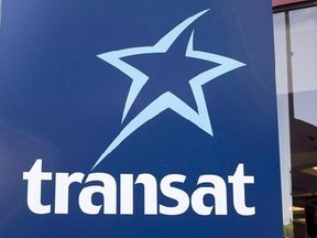 An Air Transat sign is seen Tuesday, May 31, 2016 in Montreal. Passengers trapped aboard two Air Transat jets described hours on end of sweltering heat, a lack of water and the stench of vomit earlier this summer as a federal agency began hearings Wednesday into how their ordeal happened in the first place. THE CANADIAN PRESS/Paul Chiasson