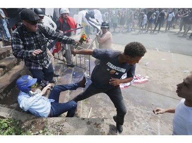 CHARLOTTESVILLE, VA - AUGUST 12:  White nationalists, neo-Nazis and members of the "alt-right" clash with counter-protesters as they attempt to guard the entrance to Lee Park during the "Unite the Right" rally August 12, 2017 in Charlottesville, Virginia. After clashes with anti-fascist protesters and police the rally was declared an unlawful gathering and people were forced out of Lee Park, where a statue of Confederate General Robert E. Lee is slated to be removed.