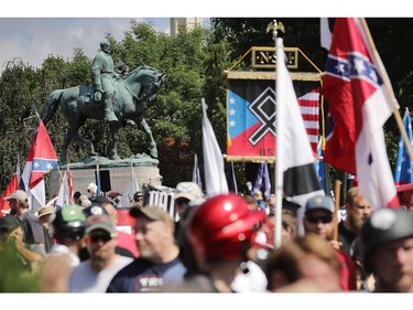 CHARLOTTESVILLE, VA - AUGUST 12:  The statue of Confederate General Robert E. Lee stands behind a crowd of hundreds of white nationalists, neo-Nazis and members of the "alt-right" during the "Unite the Right" rally August 12, 2017 in Charlottesville, Virginia. After clashes with anti-fascist protesters and police the rally was declared an unlawful gathering and people were forced out of Lee Park, where a statue of Confederate General Robert E. Lee is slated to be removed.