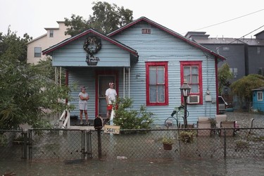 People on a porch watch as rain from Hurricane Harvey inundates the Cottage Grove neighbourhood on August 27, 2017 in Houston, Texas. Harvey, which made landfall north of Corpus Christi late Friday evening, is expected to dump upwards to 40 inches of rain in Texas over the next couple of days.