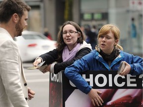 Activists with the Canadian Centre for Bio-ethical Reform try to engage pedestrians at the corner of Burrard and Robson streets in Vancouver in 2012.