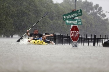 Two kayakers try to beat the current pushing them down an overflowing Brays Bayou from Tropical Storm Harvey in Houston, Texas, Sunday, Aug. 27, 2017. (Mark Mulligan/Houston Chronicle via AP) ORG XMIT: TXHOU101

MANDATORY CREDIT
Mark Mulligan, AP