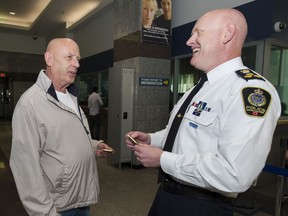 David McCann, left, gives one of the 2,000 Roger's chocolates he delivered to the VPD main station on Aug. 4, to Chief Const. Adam Palmer.