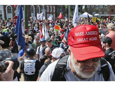 A white nationalist demonstrator walks into Lee Park in Charlottesville, Va., Saturday, Aug. 12, 2017.  Hundreds of people chanted, threw punches, hurled water bottles and unleashed chemical sprays on each other Saturday after violence erupted at a white nationalist rally in Virginia. At least one person was arrested.